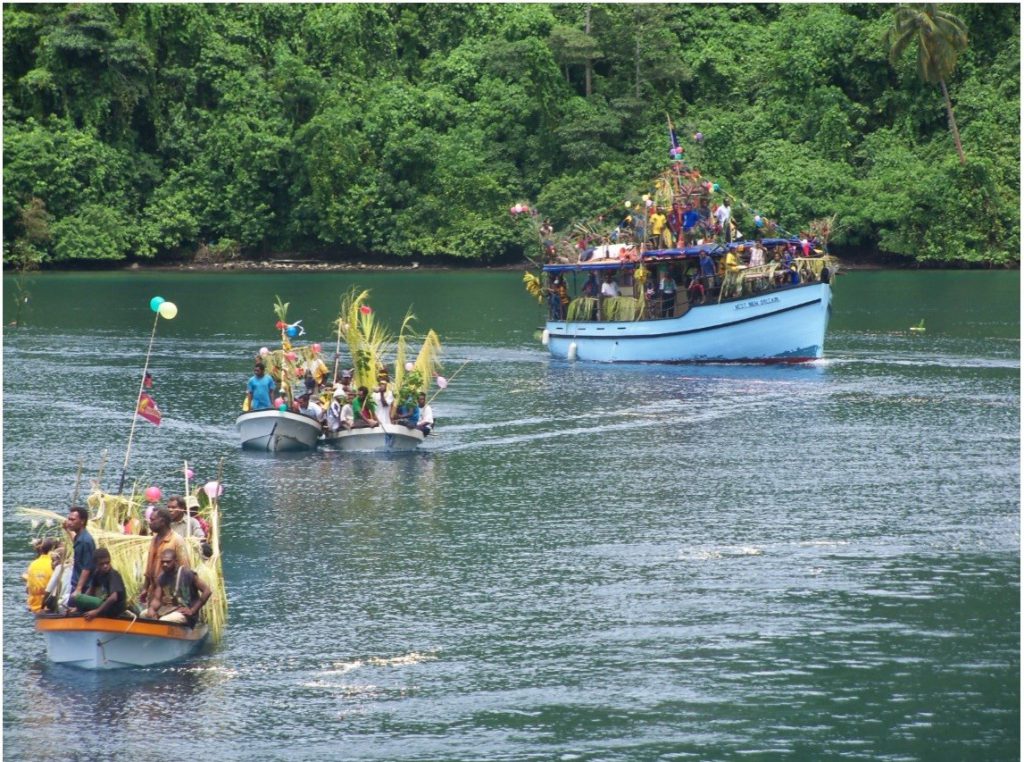 Two decorated smaller banana boats welcoming the new Inter-island motor boat MV West New Britain